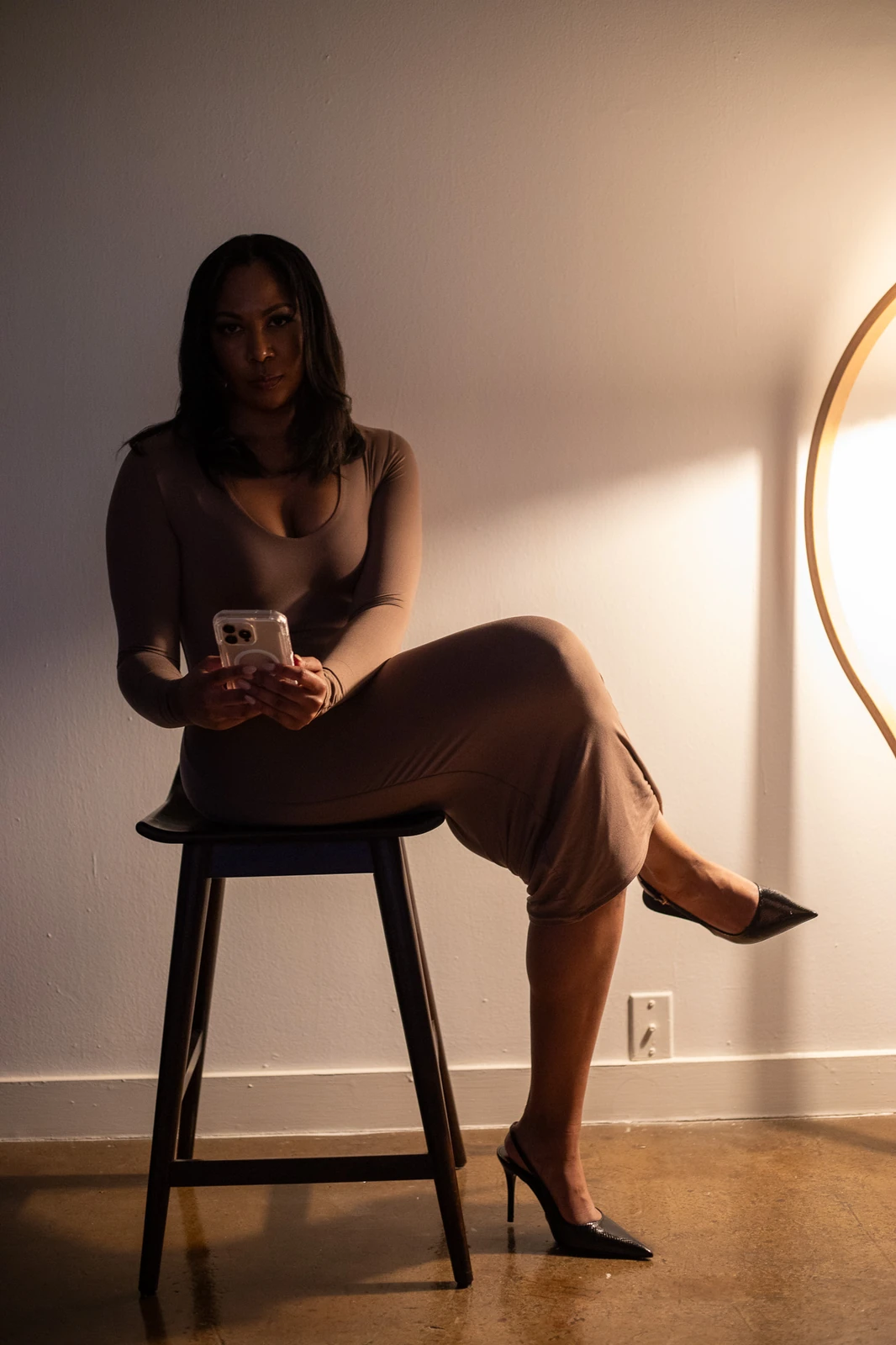 Portrait of Lydia seated in a softly lit studio setting.