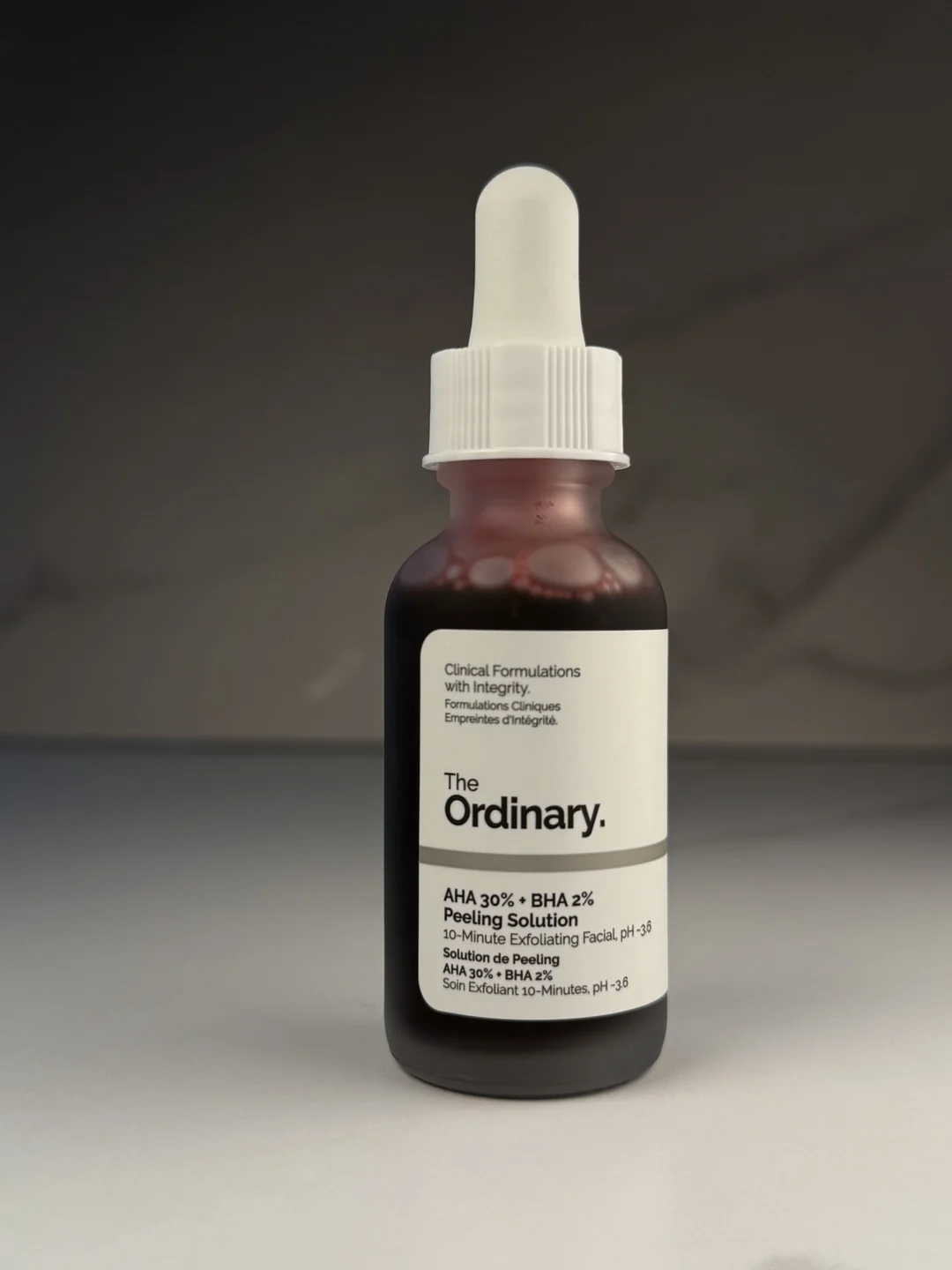 The Ordinary AHA 30 percent plus BHA 2 percent Peeling Solution bottle in neutral studio lighting.